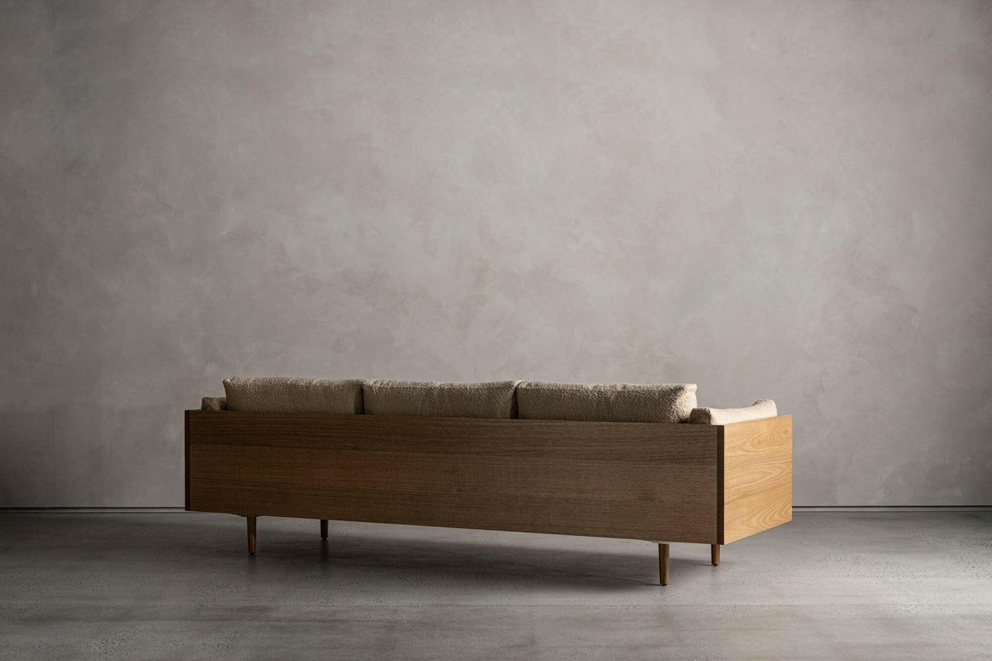 WOOD ENCASED SOFA.
